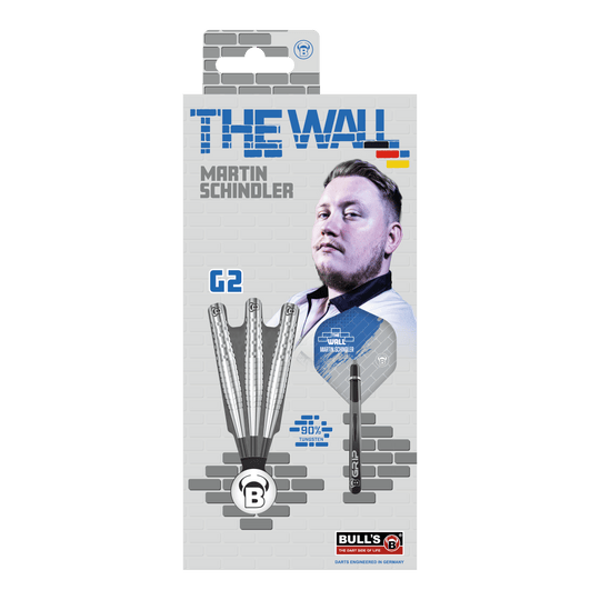 Die Verpackung zeigt die "Bulls Martin Schindler Original Generation 2 Steeldarts" mit dem Bild von Martin Schindler. Auf der Vorderseite sind drei Darts und die Aufschrift "THE WALL" sowie "90% Tungsten" abgebildet.