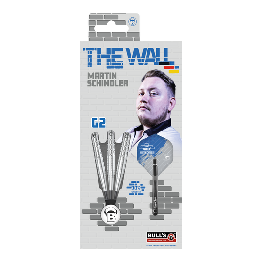 Ocelové šipky Bulls Martin Schindler Original Generation 2 Die Verpackung zeigt die "Bulls Martin Schindler Original Generation 2 Steeldarts" mit dem Bild von Martin Schindler. Auf der Vorderseite sind drei Darts und die Aufschrift "THE WALL" sowie "90% Tungsten" abgebildet.