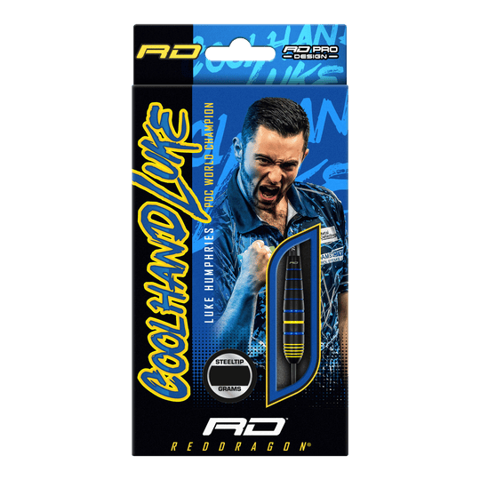 Šipky Red Dragon Luke Humphries World Champion Brass Steel Auf der Verpackung sind die "Red Dragon Luke Humphries World Champion Brass Steeldarts" abgebildet. Im Hintergrund ist ein jubelnder Spieler zu sehen, daneben ist ein Dartpfeil durch ein Sichtfenster sichtbar.